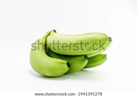 bunch of raw green bananas on white background.