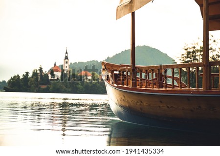 Lake Bled Slovenia. Beautiful mountain lake with small Pilgrimage Church. Traditional wooden boats on picture perfect lake Bled use for transport.