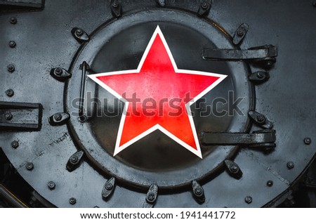Red star sign on a black vintage Soviet steam locomotive. Close up photo