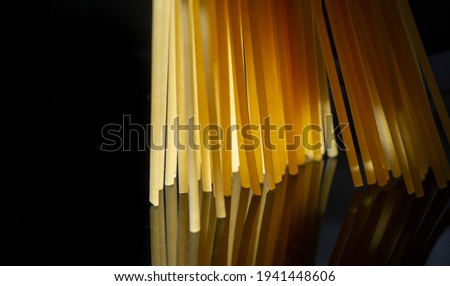 photograph of human food. Spaghetti - Long, thin, firm, cylindrical pasta with noodles. It is a staple of traditional Italian cuisine..