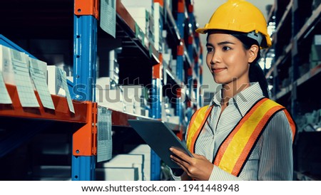 Female warehouse worker working at the storehouse . Logistics , supply chain and warehouse business concept .