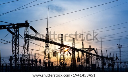 distribution electric substation with power lines and transformers, at sunset. horizontal frame. electrical distribution stations. distribution electric substation with power lines and transformers, Royalty-Free Stock Photo #1941453451