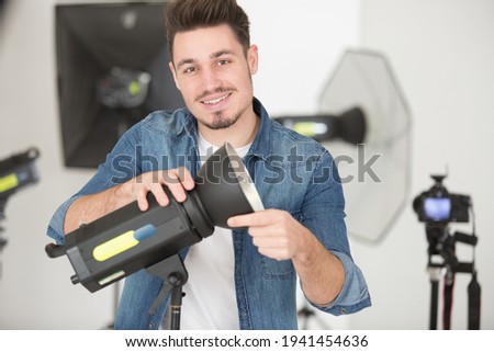 young male photographer in studio