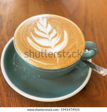 Close up picture of cappuccino in a green mug