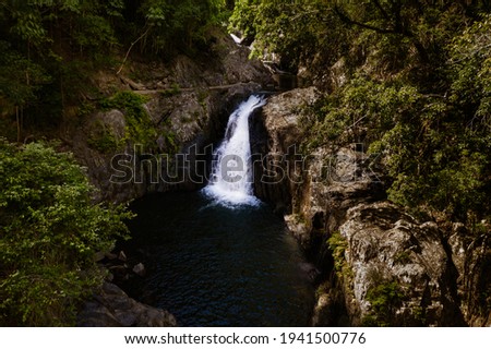 a cascading small waterfall in a small swimming cove in queensland, australia