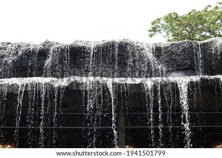 The water fall with tree and sky background