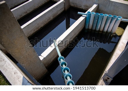 Chlorine contact basin provides disinfection of waste-water treatment plant. Royalty-Free Stock Photo #1941513700