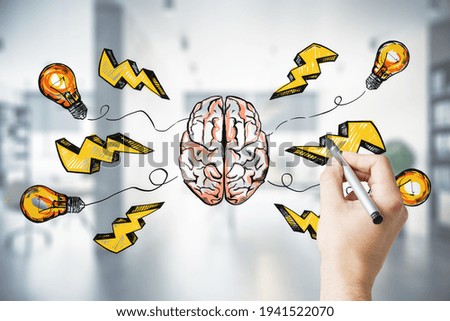 Creative idea and find solution concept with man hand drawing sketch of human brain, lightning strike signs and light bulbs on transparent screen