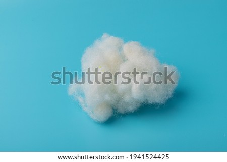 White Air Sintepon. Type Pillow Material. Sintepon Filler on blue background, soft texture Royalty-Free Stock Photo #1941524425