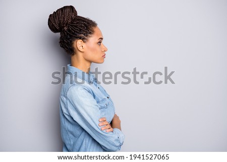 Photo portrait side profile view of african american woman with folded arms looking at blank space isolated on clear grey colored background