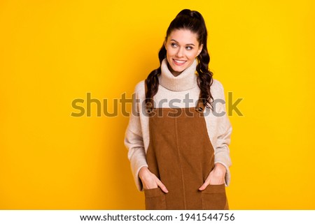 Photo of nice brunette hooray curly hairdo lady look empty space wear sweater isolated on yellow color background