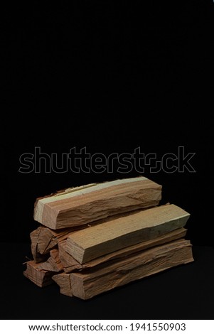 Firewood on a black background. Firewood for the stove or fireplace. Natural resource.