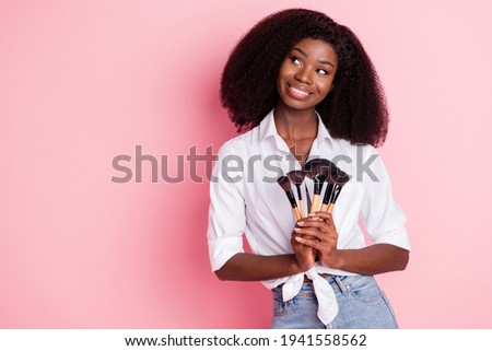 Photo of nice optimistic brunette hairdo lady apply make up look empty space wear white shirt isolated on pink color background Royalty-Free Stock Photo #1941558562
