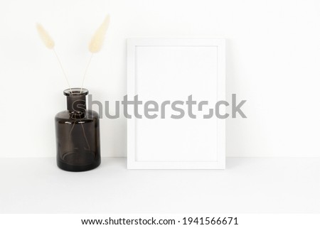 White frame mockup with black bottle
