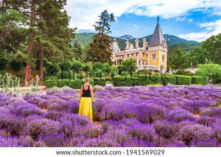 Massandra Palace in Crimea. The girl in the lavender field on the background of the castle. 
