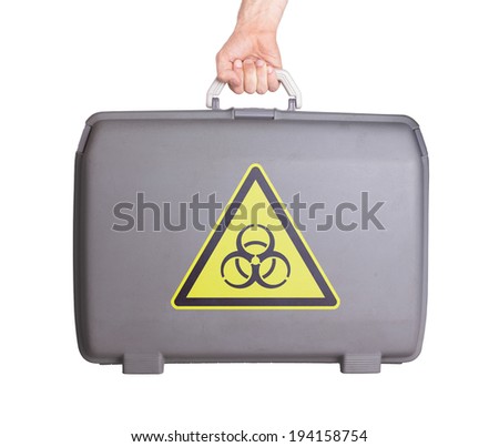 Used plastic suitcase with stains and scratches, printed with sign, danger, biohazard