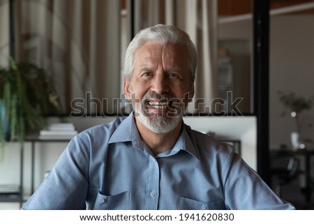 Screen headshot view of smiling mature male employee worker speak on video call in office. Portrait of happy senior middle-aged man have webcam digital online talk with client. Virtual event concept.
