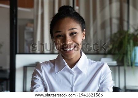 Headshot portrait of smiling African American young woman worker employee have webcam digital conference. Profile picture of happy biracial female talk speak on video call. Virtual event concept.
