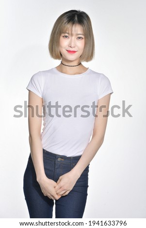 A beautiful Korean woman wearing jeans and a white shirt