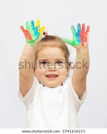 Cute little girl with painted hands. Isolated on white background.