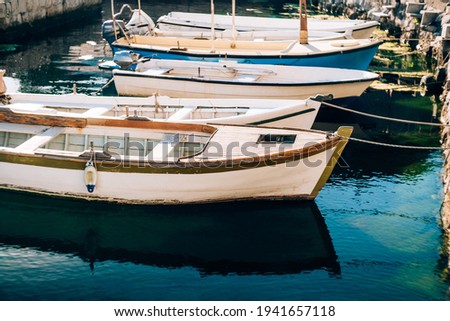 Close-up of boats tied with a rope at the pier. Royalty-Free Stock Photo #1941657118