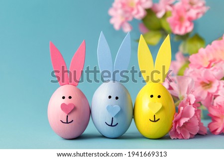 Easter egg bunny ears on blue background. DIY decoration. Happy Easter. Craft concept