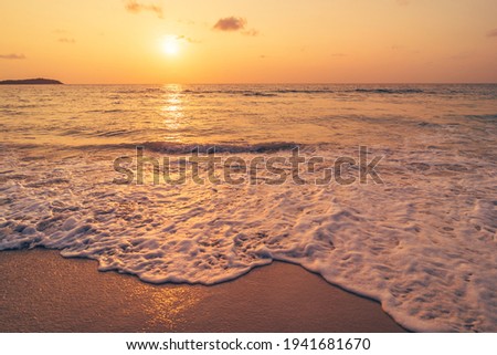 Tropical beach with smooth wave and sunset sky abstract background. Copy space of business summer vacation and travel adventure concept. Vintage tone filter effect color style.