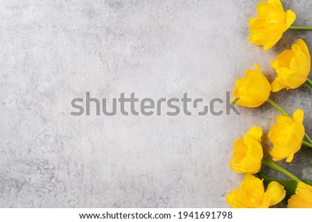 Concept of Mother's day holiday greeting design with yellow tulip flower bouquet on gray background