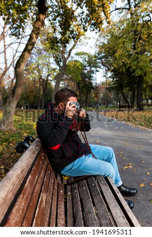 Photographer with vintage analogue film camera outdoors 