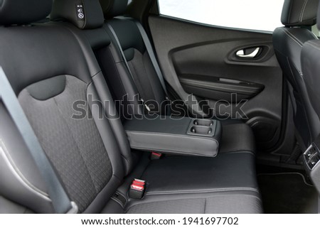 Armrest in the car with cup holder for rear seats row Royalty-Free Stock Photo #1941697702