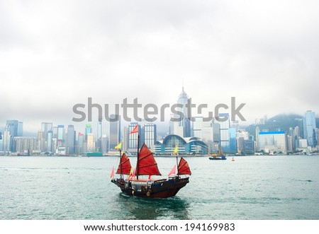 View on Hong Kong downtown from the sea with traditional chinese sailboat Royalty-Free Stock Photo #194169983