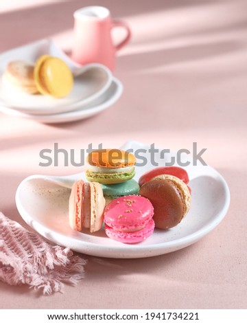 Colorful macarons on white plate.