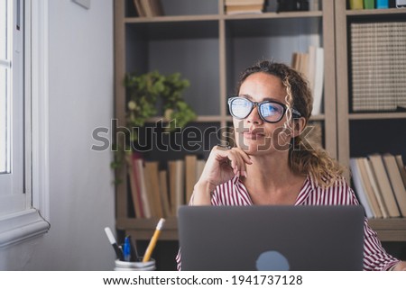 Caucasian reflexive looking at laptop screen, reflexing on work, businesswoman independent working in a difficult project. Female person preparing at home in the office indoor. Royalty-Free Stock Photo #1941737128