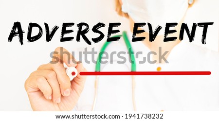 The doctor writes the text ADVERSE EVENT with a marker. Medical.