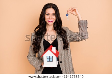 Photo of charming cute young lady dressed checkered blazer holding house keys isolated beige color background