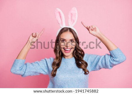 Photo of excited promoter lady direct fingers headband wear bunny ears blue pullover isolated pink background