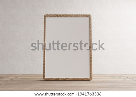 Empty wooden frame with space for inscription against a white wall. Wooden frame. 3D rendering