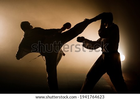 Karate man, fighter or athlete, barefoot in kimono, suit, with black belt training