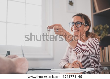 Crop close up of realtor give keys to man buyer or renter buying first home from agency. Real estate agent or broker congratulate male tenant with house or flat purchase. Ownership, rental concept. Royalty-Free Stock Photo #1941771145