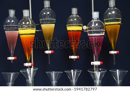 separating natural product use dichloromethane with water have two layer colorful and white in separating funnel is drug research  process Royalty-Free Stock Photo #1941782797