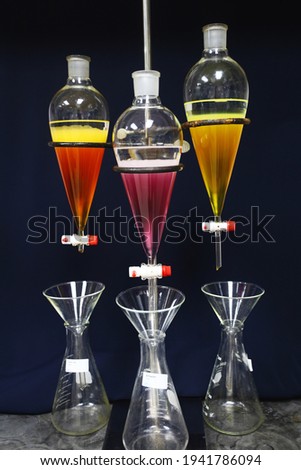 separating natural product use dichloromethane with water have two layer colorful and white in separating funnel is drug research  process Royalty-Free Stock Photo #1941786094