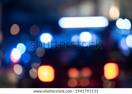 Detail of Blurred emergency background with blue lights in the city at night