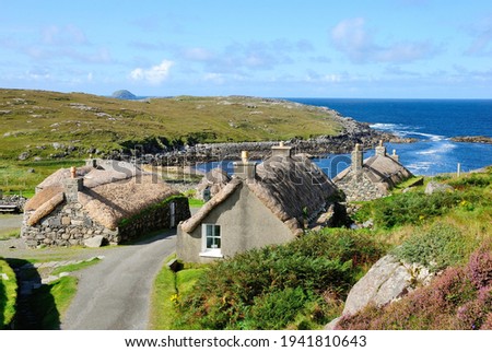 Garenin blackhouse village on the west coast of the Isle of Lewis in the Outer Hebrides of Scotland, UK on a beautiful sunny day with a view of a Garenin bay Royalty-Free Stock Photo #1941810643