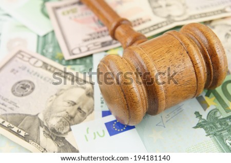 Judge gavel on dollar and euro banknotes background