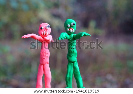 Funny colorful zombie figures in the forest.