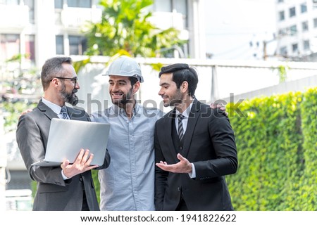 Two Businessman and power engineering talking and checking quality power solar cell with laptop computor on site new project power solution business