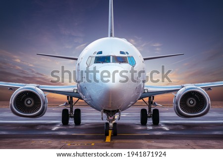 modern airliner at an airfield while sunset Royalty-Free Stock Photo #1941871924
