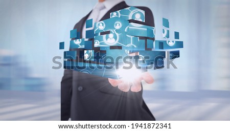 Composition of network of digital people icons over hand of businessman. global technology and digital interface concept digitally generated image.