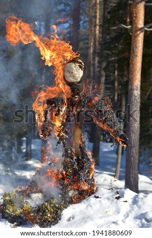 Burning scarecrow on festival maslenitsa. Slavic national spring pagan festival - Maslenitsa. Burning effigies straw on traditional holiday dedicated to spring - slavic celebration shrovetide