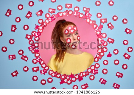 narcissistic woman loves attention, on Internet. portrait of redhead female among likes buttons